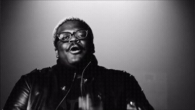 A Black And White Photo Of A Man With Glasses And A Mustache GIF