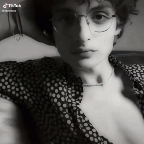 A Black And White Photo Of A Man With Glasses And A Polka Dot Shirt With Tiktok Written On The Bottom GIF