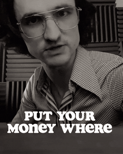 A Black And White Photo Of A Man With Glasses And The Words Put Your Money Where Below Him GIF