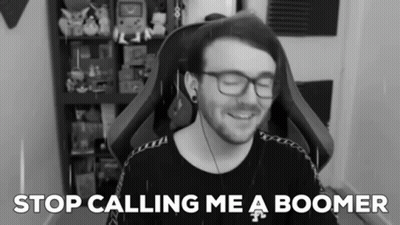 A Black And White Photo Of A Man With Glasses And The Words " Stop Calling Me A Boomer " Behind Him GIF