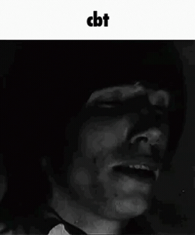 A Black And White Photo Of A Man With His Eyes Closed And A Shadow On His Face . GIF