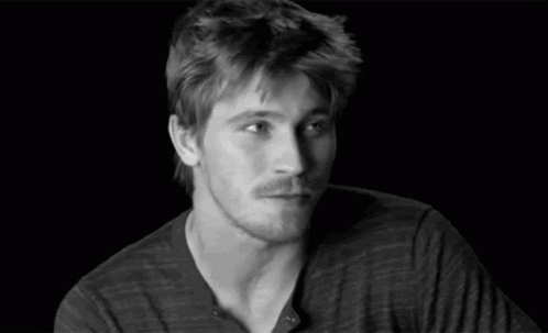 A Black And White Photo Of A Man With His Eyes Closed And His Hands Up . GIF