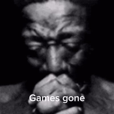 A Black And White Photo Of A Man With His Hands Folded And The Words `` Games Gone '' Written On It . GIF