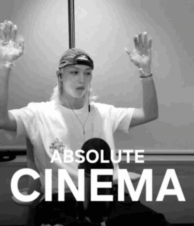 A Black And White Photo Of A Man With His Hands In The Air And The Words Absolute Cinema Below Him GIF