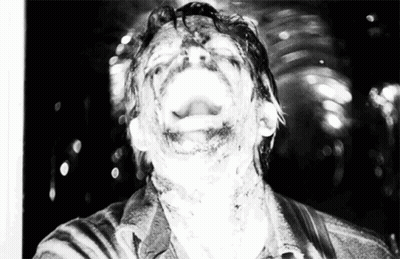 A Black And White Photo Of A Man With His Mouth Wide Open GIF