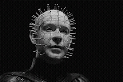 A Black And White Photo Of A Man With Nails In His Head And The Words " Your Holes Apart " GIF