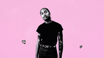 A Black And White Photo Of A Man With Tattoos On His Arms Standing On A Pink Background . GIF