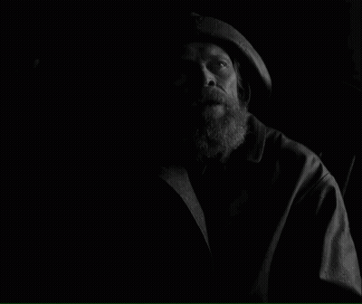 A Black And White Photo Of A Man With The Words How Long Have We Been On This Rock Below Him GIF