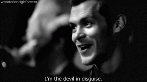 A Black And White Photo Of A Man With The Words " I 'M The Devil In Disguise " GIF