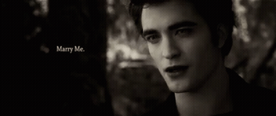 A Black And White Photo Of A Man With The Words Marry Me Written Above Him GIF