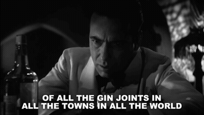 A Black And White Photo Of A Man With The Words Of All The Gin Joints In All The Towns In All The World Behind Him GIF