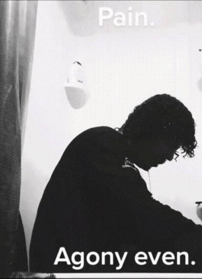 A Black And White Photo Of A Man With The Words Pain Agony Even Below Him GIF