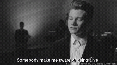A Black And White Photo Of A Man With The Words Somebody Make Me Aware Of Being Alive Below Him GIF