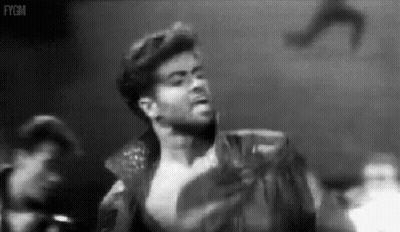 A Black And White Photo Of A Man Without A Shirt On A Stage . GIF