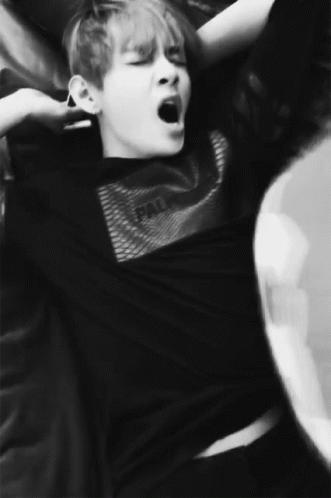 A Black And White Photo Of A Man Yawning GIF