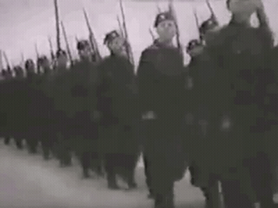 A Black And White Photo Of A Military Parade With Soldiers Marching In A Line . GIF