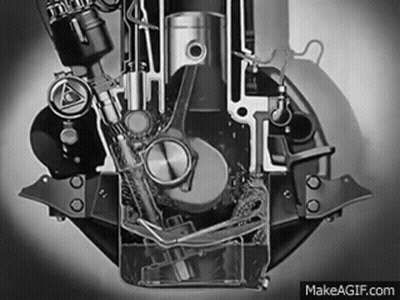 A Black And White Photo Of A Motorcycle Engine With Water Coming Out Of It . GIF