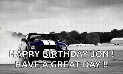 A Black And White Photo Of A Mustang Drifting On A Race Track . GIF