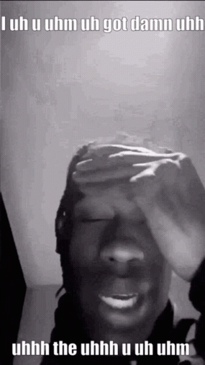 A Black And White Photo Of A Person Covering Their Face With Their Hand . GIF