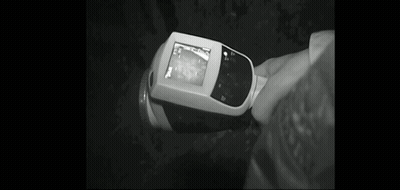 A Black And White Photo Of A Person Holding A Cell Phone . GIF