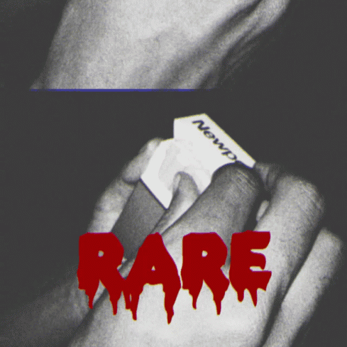 A Black And White Photo Of A Person Holding A Piece Of Paper With The Word Rare In Red GIF