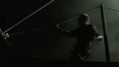 A Black And White Photo Of A Person Holding A Rope In The Water GIF