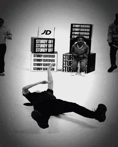 A Black And White Photo Of A Person Holding A Sign That Says Sturdy Off Sturdy Off Sturdy Off GIF