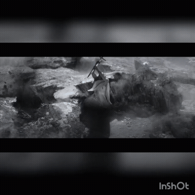 A Black And White Photo Of A Person Holding A Sword With The Word Inshot At The Top GIF