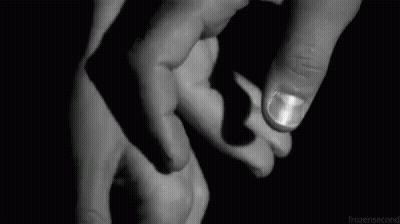 A Black And White Photo Of A Person Holding Another Person 'S Hand . GIF