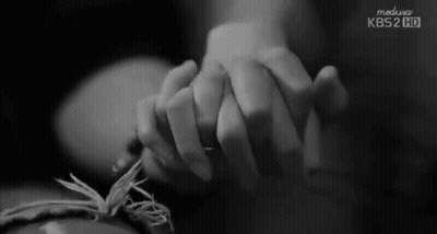 A Black And White Photo Of A Person Holding Another Person 'S Hand With Kbs2 Hd Written On The Bottom GIF