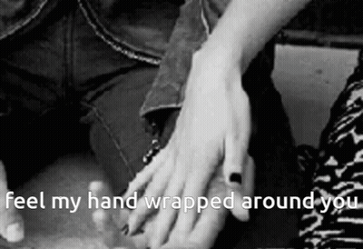 A Black And White Photo Of A Person Holding Another Person 'S Hand With The Caption " Feel My Hand Wrapped Around You "  GIF