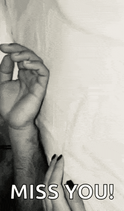 A Black And White Photo Of A Person Holding Another Person 'S Hand With The Words `` Miss You '' Written On It . GIF