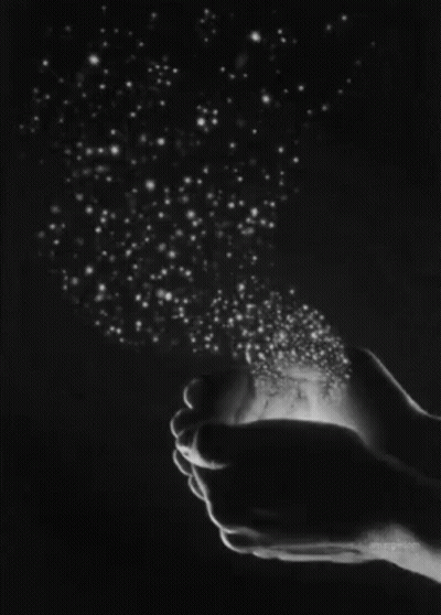 A Black And White Photo Of A Person Holding Stars In Their Hands . GIF