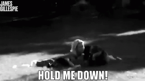 A Black And White Photo Of A Person In The Water With The Words Hold Me Down Below Them GIF