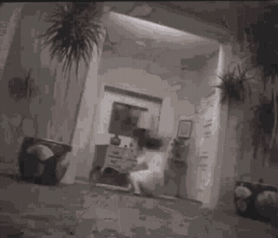 A Black And White Photo Of A Person Laying On A Couch With Their Legs Crossed . GIF