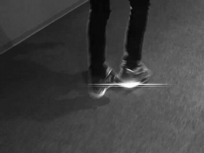 A Black And White Photo Of A Person Laying On The Floor With Their Head Down . GIF