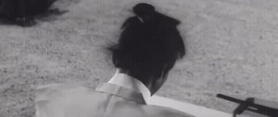 A Black And White Photo Of A Person Laying On The Ground With A Shadow On The Ground . GIF