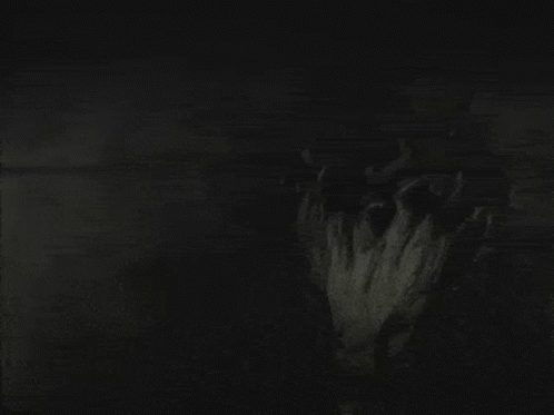 A Black And White Photo Of A Person 'S Face In The Dark GIF