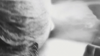 A Black And White Photo Of A Person 'S Face With A Hat On . GIF