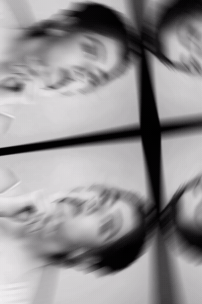 A Black And White Photo Of A Person 'S Face With A Reflection GIF
