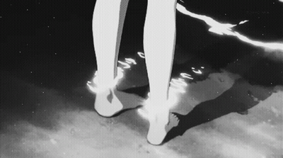 A Black And White Photo Of A Person 'S Feet Standing On A Beach . GIF