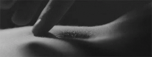 A Black And White Photo Of A Person 'S Finger Touching A Hole In Their Stomach . GIF