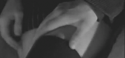 A Black And White Photo Of A Person 'S Hand On A Woman 'S Leg . GIF
