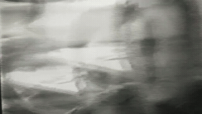 A Black And White Photo Of A Person 'S Shadow On A Wall GIF