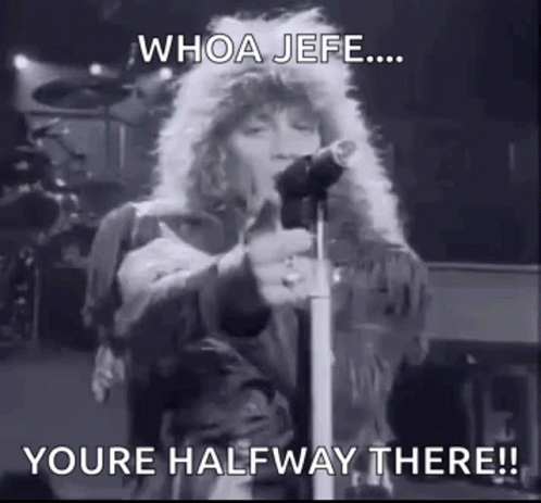 A Black And White Photo Of A Person Singing Into A Microphone On A Stage . GIF