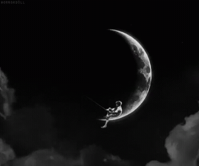 A Black And White Photo Of A Person Sitting On A Swing On A Crescent Moon . GIF