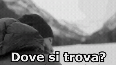 A Black And White Photo Of A Person Sleeping In The Snow With The Words `` Dove Si Trova '' Written On The Bottom . GIF