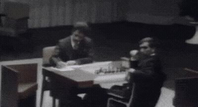 A Black And White Photo Of A Person Standing In A Room With Their Arms Outstretched . GIF