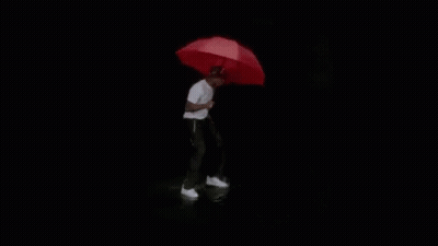 A Black And White Photo Of A Person Standing In The Water . GIF