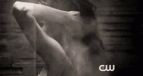 A Black And White Photo Of A Person Taking A Shower With The Words Cw Written On The Bottom . GIF